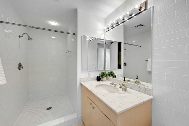 bathroom featuring vanity and a tile shower