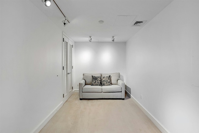 sitting room featuring rail lighting