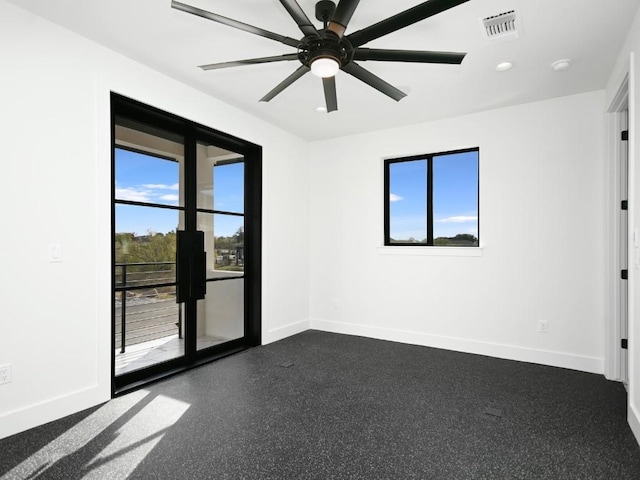 spare room featuring ceiling fan and a healthy amount of sunlight