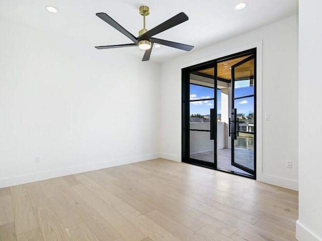 empty room with ceiling fan and light hardwood / wood-style floors