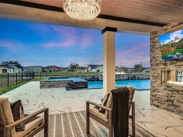 view of patio with a pool with hot tub and an outdoor stone fireplace