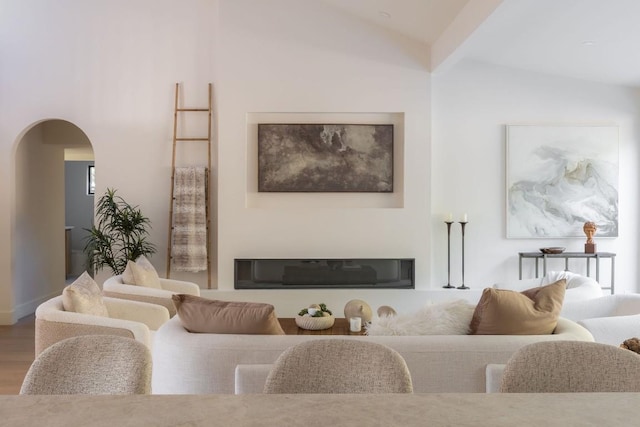 living room with hardwood / wood-style floors and lofted ceiling with beams