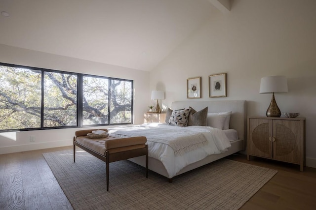 bedroom with high vaulted ceiling, beam ceiling, and hardwood / wood-style floors