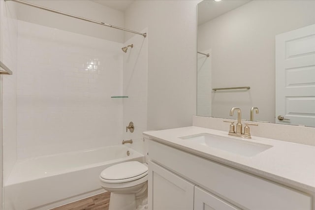 full bathroom featuring wood-type flooring, shower / washtub combination, vanity, and toilet