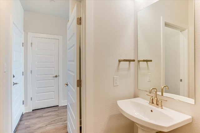 bathroom featuring wood-type flooring and sink