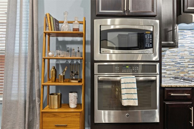 kitchen featuring light stone counters, backsplash, appliances with stainless steel finishes, and dark brown cabinets