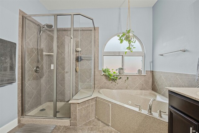 full bathroom with a shower stall, vanity, and a garden tub