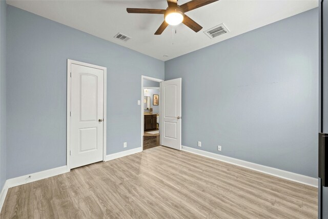 unfurnished bedroom with visible vents, a ceiling fan, light wood-type flooring, and baseboards