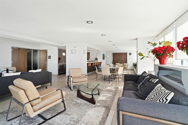 living room with wine cooler and wood-type flooring