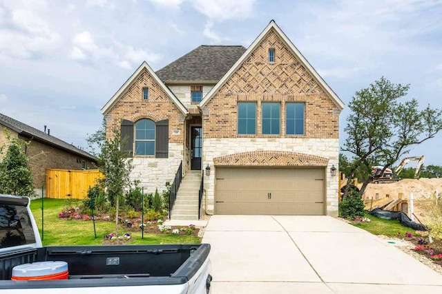 128 Spring Bluff Ln, Georgetown, TX 78628 - view of front facade with stone siding, a garage, concrete driveway, and brick siding