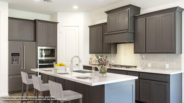 128 Spring Bluff Ln, Georgetown, TX 78628 - kitchen with stainless steel appliances, decorative backsplash, a breakfast bar, light countertops, and recessed lighting