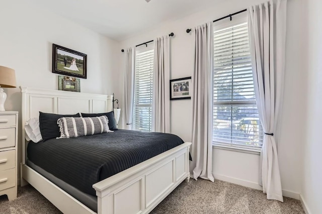 carpeted bedroom featuring multiple windows