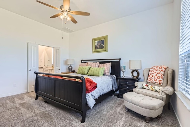 carpeted bedroom with ceiling fan and ensuite bath