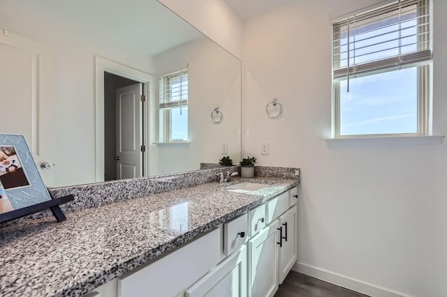 bathroom with vanity and hardwood / wood-style floors