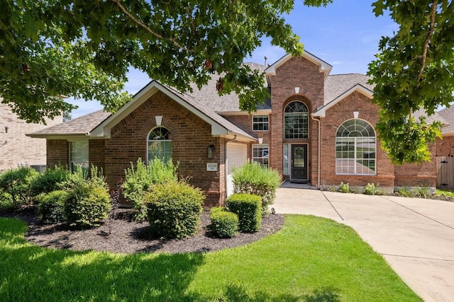 view of front property featuring a garage and a front lawn