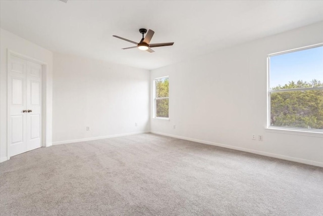 empty room featuring carpet flooring and ceiling fan