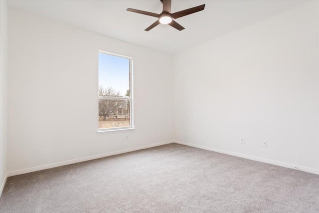 empty room featuring ceiling fan and carpet