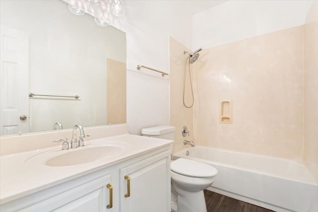 full bathroom featuring wood-type flooring, toilet, tub / shower combination, and vanity