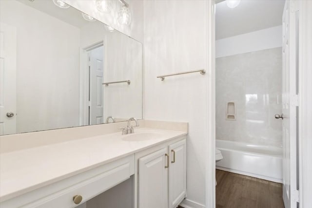 full bathroom featuring vanity, hardwood / wood-style floors, tub / shower combination, and toilet