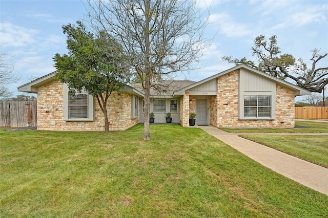 ranch-style home with a garage and a front yard