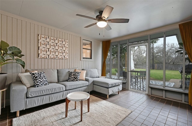 tiled living room with wooden walls and ceiling fan