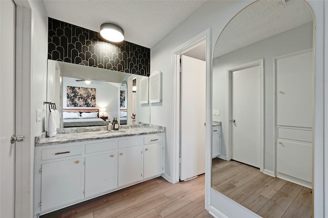 bathroom featuring vanity and a textured ceiling