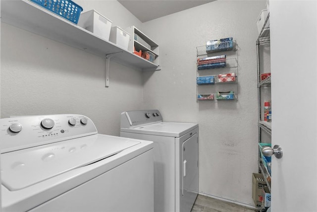 clothes washing area featuring washer and clothes dryer