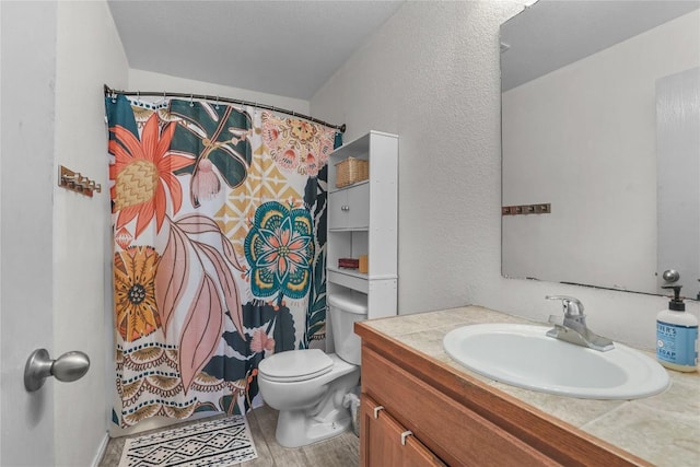 bathroom featuring vanity, hardwood / wood-style floors, and toilet