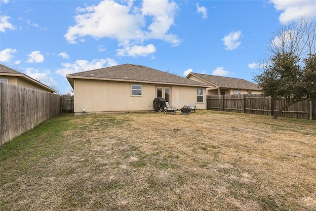 rear view of house featuring a yard