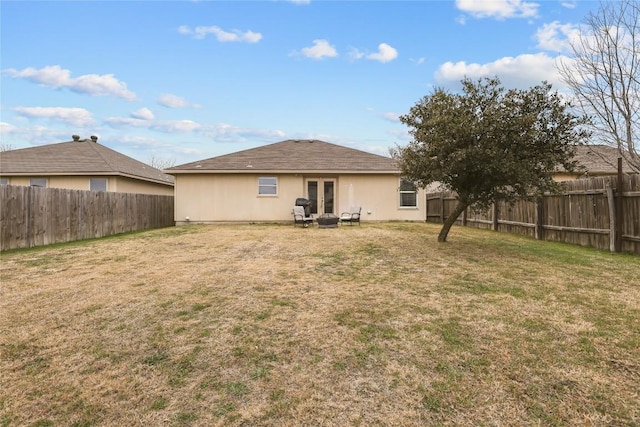 back of property featuring a yard