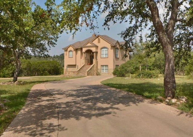 view of front of home with a garage and a front lawn