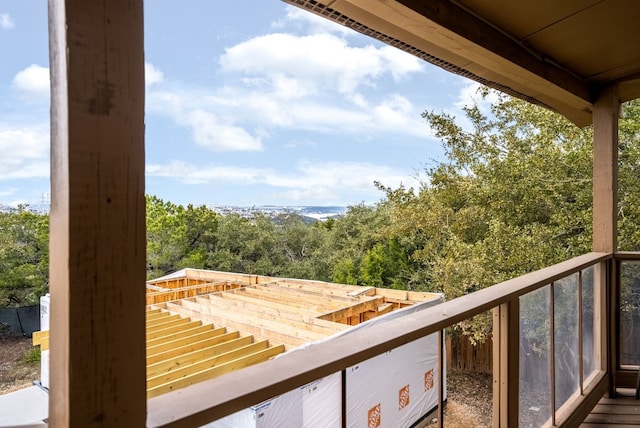 balcony featuring a view of trees