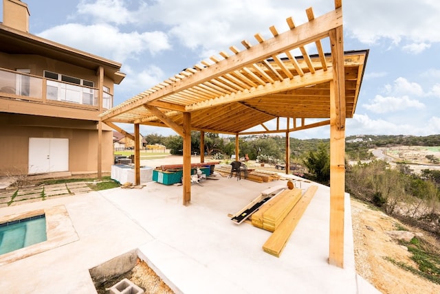 view of patio / terrace with a jacuzzi and a pergola