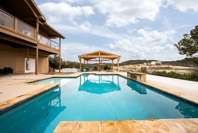 outdoor pool featuring a gazebo and a patio area