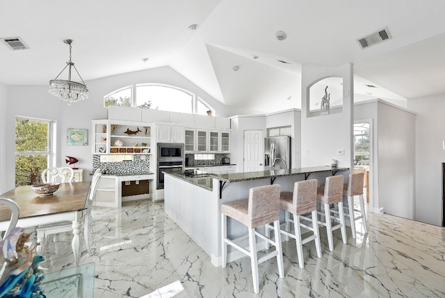 kitchen featuring stainless steel appliances, marble finish floor, visible vents, and decorative backsplash