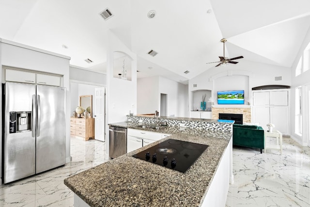 kitchen with visible vents, marble finish floor, stainless steel appliances, a fireplace, and a sink