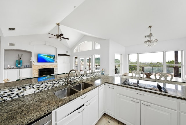 kitchen featuring a healthy amount of sunlight, marble finish floor, visible vents, and a sink