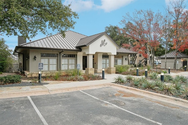 view of building exterior with uncovered parking