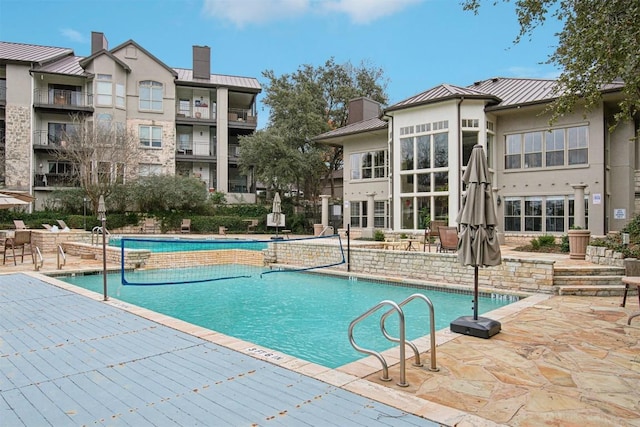 view of swimming pool featuring a patio