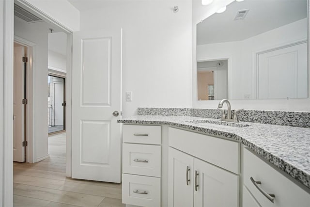 bathroom featuring vanity and hardwood / wood-style flooring