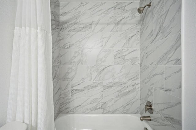 bathroom featuring toilet and shower / tub combo with curtain