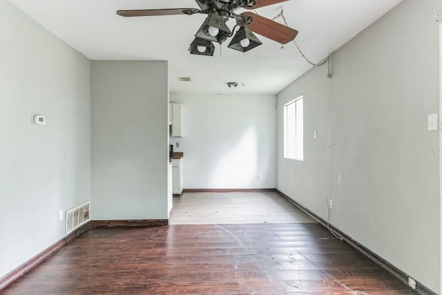 unfurnished room featuring dark hardwood / wood-style floors and ceiling fan