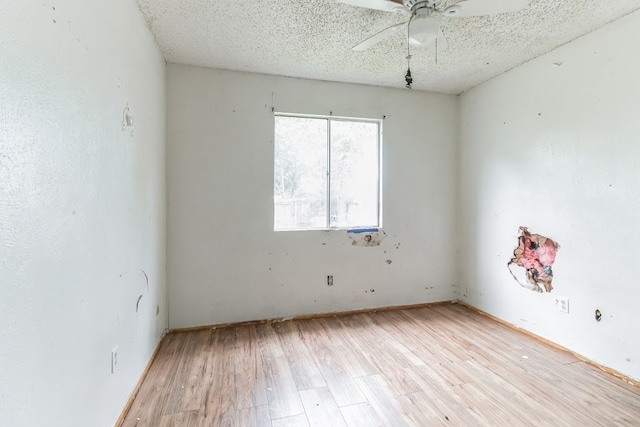 unfurnished room featuring ceiling fan, a textured ceiling, and light wood-type flooring