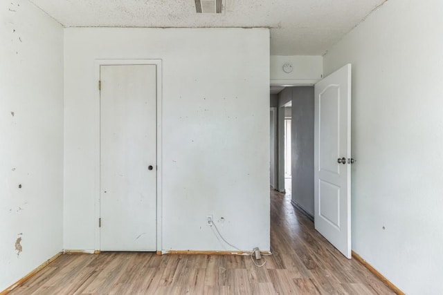 spare room featuring hardwood / wood-style flooring