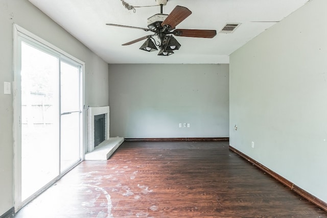 unfurnished living room with dark hardwood / wood-style floors and ceiling fan