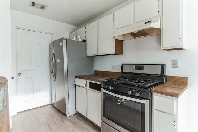 kitchen featuring white cabinetry, appliances with stainless steel finishes, wood counters, and light wood-type flooring