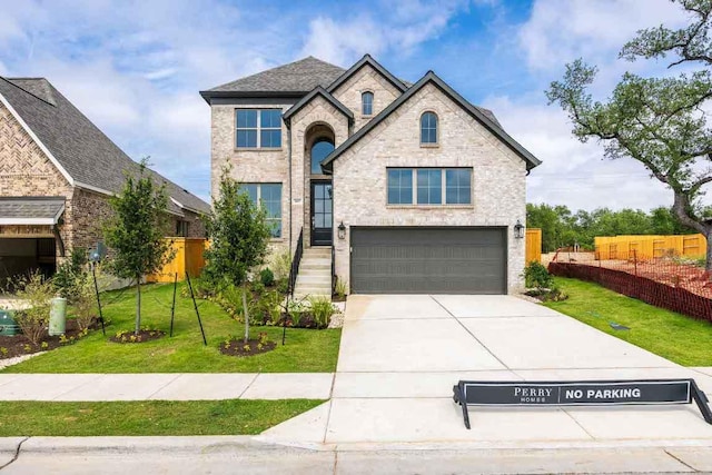 140 Spring Bluff Ln, Georgetown, TX 78628 - french provincial home featuring an attached garage, driveway, and stone siding