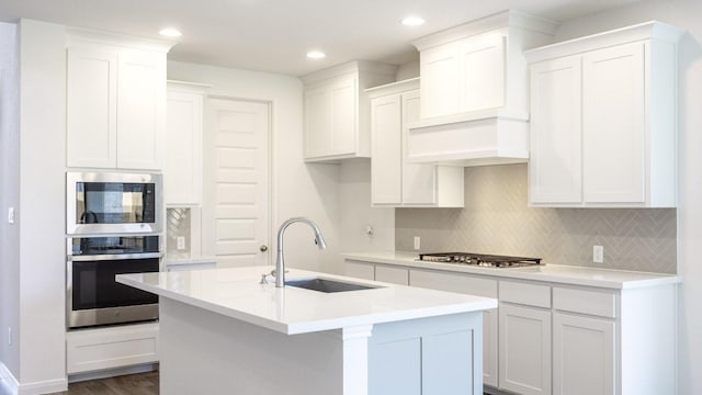 140 Spring Bluff Ln, Georgetown, TX 78628 - kitchen featuring stainless steel appliances, tasteful backsplash, a center island with sink, white cabinetry, and recessed lighting