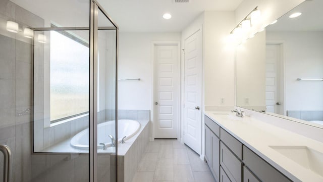 140 Spring Bluff Ln, Georgetown, TX 78628 - full bath with double vanity, a garden tub, a shower stall, and recessed lighting