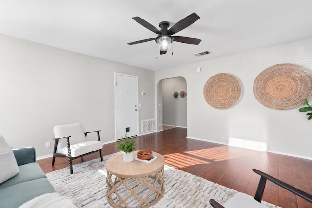 living room with wood-type flooring and ceiling fan